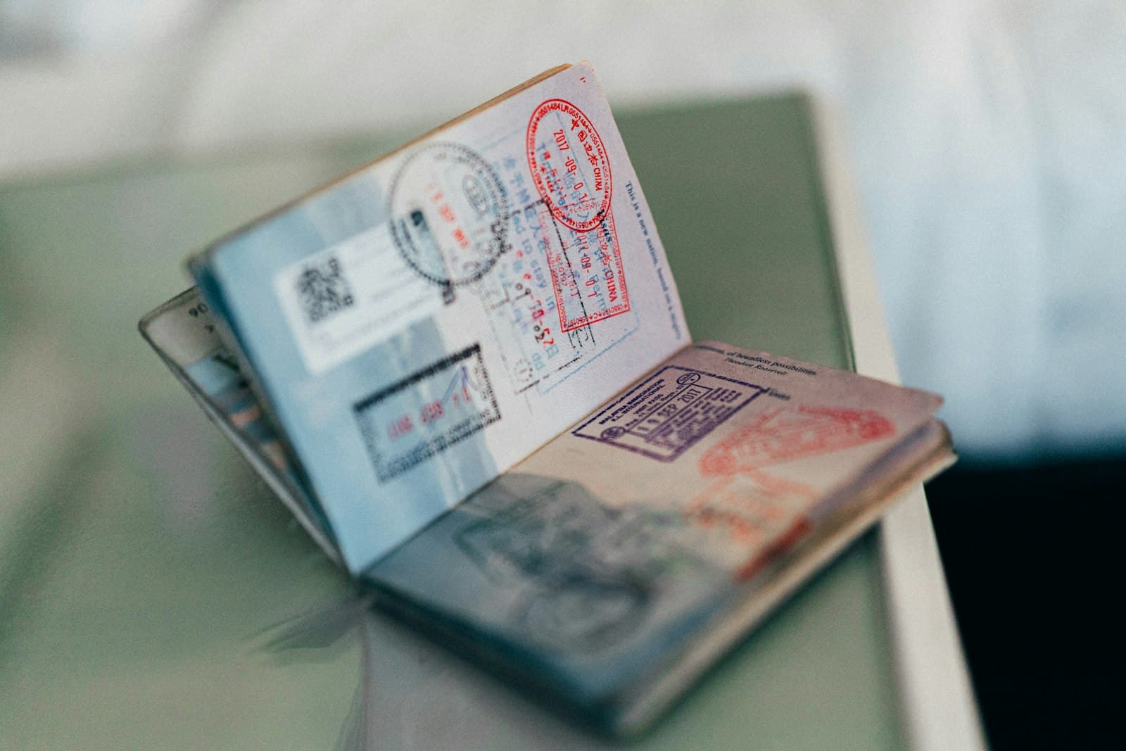 An open passport showing visa and entry stamps from several countries